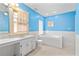 Bright bathroom features a double vanity and a luxurious soaking tub at 2265 E Lake Ne Rd, Atlanta, GA 30307