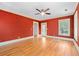 Spacious bedroom with hardwood floors, red walls, ceiling fan, and natural light at 2265 E Lake Ne Rd, Atlanta, GA 30307