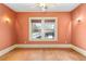 A simple peach-colored bedroom features hardwood floors, natural light, and vintage wall sconces at 2265 E Lake Ne Rd, Atlanta, GA 30307