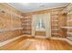 Walk-in closet with wood floors and custom shelving offering ample storage space at 2265 E Lake Ne Rd, Atlanta, GA 30307