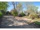 A gravel driveway with a parked SUV, and some lush green trees surrounding at 2265 E Lake Ne Rd, Atlanta, GA 30307