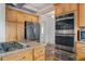Gourmet kitchen with double ovens, granite counters, stone floors and stainless steel appliances at 2265 E Lake Ne Rd, Atlanta, GA 30307