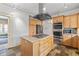 Renovated kitchen with stainless appliances, stone flooring, granite island, and custom cabinets at 2265 E Lake Ne Rd, Atlanta, GA 30307