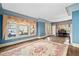 Well-lit living room featuring large windows, hardwood floors, and a piano at 2265 E Lake Ne Rd, Atlanta, GA 30307