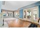 Spacious living room with hardwood floors, fireplace, large windows, and french doors at 2265 E Lake Ne Rd, Atlanta, GA 30307
