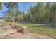 The backyard features a spacious grassy area with brick patio and lush trees at 2836 Waters Sw Rd, Atlanta, GA 30354