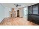 Living area featuring hardwood floors, a fireplace, dark wood cabinet and access to other rooms at 2836 Waters Sw Rd, Atlanta, GA 30354