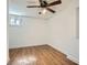 Bedroom with ceiling fan, white walls, window, and light colored wood-look flooring at 2836 Waters Sw Rd, Atlanta, GA 30354