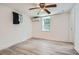 Cozy bedroom with a ceiling fan, AC unit, window, and light-colored wood-look floors at 2836 Waters Sw Rd, Atlanta, GA 30354