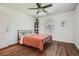 A bedroom features hardwood floors, a dark-colored metal bed frame and white walls and trim at 2836 Waters Sw Rd, Atlanta, GA 30354