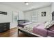 A bedroom features hardwood floors, a dark-colored wooden bed frame and dresser with two windows at 2836 Waters Sw Rd, Atlanta, GA 30354