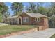 Beautiful home with brick accents, a well-maintained lawn, and a long driveway at 2836 Waters Sw Rd, Atlanta, GA 30354
