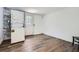 A compact laundry area featuring a stacked washer and dryer unit with a wood-look accent wall at 2836 Waters Sw Rd, Atlanta, GA 30354