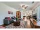 Comfortable living room with hardwood floors, ceiling fan, and seamless flow to the dining area at 2836 Waters Sw Rd, Atlanta, GA 30354