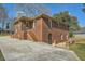 Brick home featuring a staircase leading to an upper level entrance and a long driveway at 2836 Waters Sw Rd, Atlanta, GA 30354