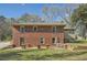 Back of brick home featuring an upper entrance, well-kept lawn, and ample parking space at 2836 Waters Sw Rd, Atlanta, GA 30354