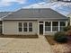 Back exterior of the home with a patio, lush landscaping, and a screened porch at 3905 Delfaire Trce, Cumming, GA 30040
