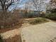 Backyard featuring stone walkway, shrubbery, and partial wooden fence at 3905 Delfaire Trce, Cumming, GA 30040