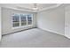Bedroom featuring neutral carpet, a ceiling fan, and large windows at 3905 Delfaire Trce, Cumming, GA 30040