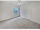 Bedroom featuring neutral carpeting, lighted ceiling fan and double door closet at 3905 Delfaire Trce, Cumming, GA 30040
