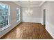 Dining room with hardwood floors, crown molding, and a modern chandelier at 3905 Delfaire Trce, Cumming, GA 30040