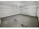 Spacious two car garage providing ample storage with overhead door, and shelving unit at 3905 Delfaire Trce, Cumming, GA 30040