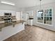 Bright eat-in kitchen with white cabinets, granite countertops, and stainless steel appliances at 3905 Delfaire Trce, Cumming, GA 30040