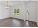 Elegant dining area featuring wainscoting, wood-look floors, and a modern chandelier for stylish meals at 372 Waterbluff Dr, Mableton, GA 30126