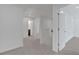 Upstairs hallway with carpet floors and open doors to other rooms at 372 Waterbluff Dr, Mableton, GA 30126