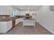 Modern kitchen featuring white cabinets, stainless steel appliances, and a center island for meal preparation at 372 Waterbluff Dr, Mableton, GA 30126