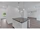 Kitchen island featuring barstool seating and modern pendant lighting at 372 Waterbluff Dr, Mableton, GA 30126