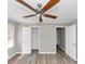 Neutral bedroom featuring hardwood flooring, a ceiling fan, neutral paint, and a closet at 3811 Turner Heights Dr, Decatur, GA 30032