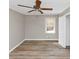 Neutral bedroom featuring hardwood flooring, a ceiling fan, neutral paint, and a bright window at 3811 Turner Heights Dr, Decatur, GA 30032