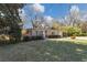 Well-kept single-story home featuring a manicured lawn, brick accents, and covered parking at 3811 Turner Heights Dr, Decatur, GA 30032