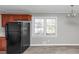 Modern kitchen with a black fridge, wood cabinets, and natural lighting at 3811 Turner Heights Dr, Decatur, GA 30032