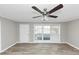 Bright living room with hardwood floors, a ceiling fan, and large windows at 3811 Turner Heights Dr, Decatur, GA 30032