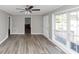 Spacious living room features wood flooring, natural light, and a ceiling fan at 3811 Turner Heights Dr, Decatur, GA 30032