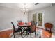 Cozy dining area with hardwood floors, decorative chandelier, and a round dining table at 787 Faye Nw Dr, Kennesaw, GA 30144