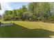 Large backyard with statues and a small patio at 2485 Field Spring Dr, Stonecrest, GA 30058