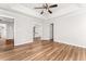 Open bedroom layout with hardwood floors and a tray ceiling with a ceiling fan at 2485 Field Spring Dr, Stonecrest, GA 30058