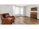 Cozy bedroom with hardwood floors, bay windows, and a comfortable chair at 2485 Field Spring Dr, Stonecrest, GA 30058