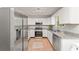 Modern kitchen with stainless steel appliances, granite countertops, tile floors, and white cabinetry at 2485 Field Spring Dr, Stonecrest, GA 30058