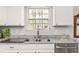 Bright kitchen features granite countertops, stainless steel appliances, and a window over the sink at 2485 Field Spring Dr, Stonecrest, GA 30058