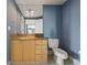 Bathroom showcasing a wood vanity with granite countertop, tiled floors, and modern toilet fixture at 3338 Peachtree Ne Rd # 2804, Atlanta, GA 30326