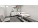 Modern spa treatment room equipped with comfortable massage table, a chair, and soothing décor at 3338 Peachtree Ne Rd # 2804, Atlanta, GA 30326