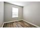 A cozy bedroom features wood-look floors, neutral walls, and a bright window at 344 Springbottom Ct, Lawrenceville, GA 30046