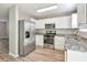 Modern kitchen with stainless steel appliances, granite countertops, and white cabinets at 344 Springbottom Ct, Lawrenceville, GA 30046