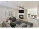 Living room features a fireplace, ceiling fan, light wood floors, and plenty of space for furniture at 344 Springbottom Ct, Lawrenceville, GA 30046