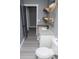 Chic bathroom with modern granite countertops, toilet and stylish design with floating shelves and vanity at 116 Carroll St, Temple, GA 30179