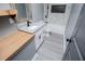 Modern bathroom showcasing granite countertops, floating shelves, and a sleek tiled shower with black accents at 116 Carroll St, Temple, GA 30179